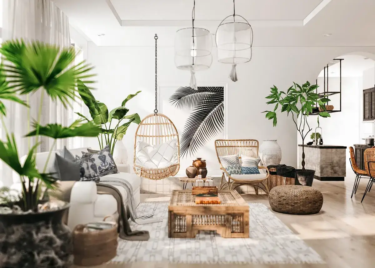 Jasny salon w stylu hampton z wiklinowym fotelem wiszącym, rattanowymi meblami i bujną roślinnością.